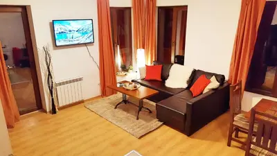 a living room with a couch and a table at Bansko front door to the Gondola and town centre in Bansko