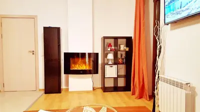 a living room with a fireplace in the wall at Bansko front door to the Gondola and town centre in Bansko