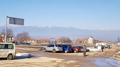 a group of cars parked in a parking lot with mountains in the background at Bansko front door to the Gondola and town centre in Bansko