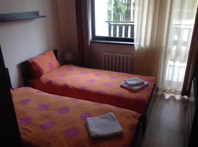a small room with two beds and a window at Borovest Garden. in Borovets