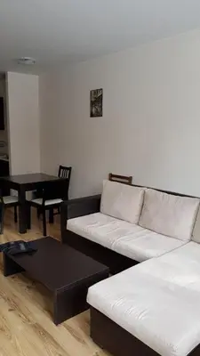 a living room with a white couch and a table at Borovest Garden. in Borovets