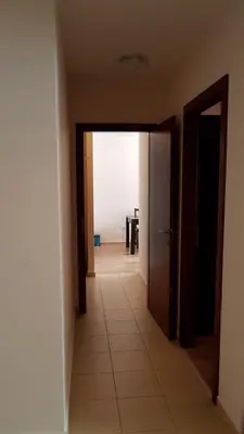 an empty hallway with an open door and a table at Borovest Garden. in Borovets