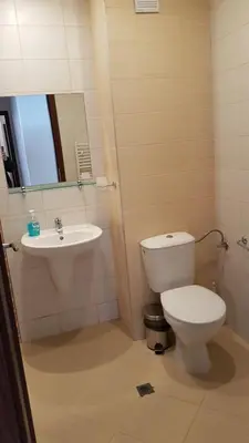 a bathroom with a toilet and a sink at Borovest Garden. in Borovets