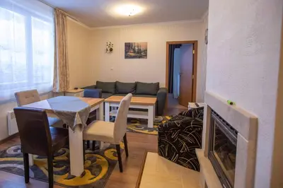 a living room with a table and a couch at Apartments in Complex Grand Manastira in Pamporovo