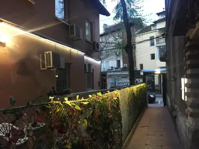 an alley way with a fence and a building at Elegance on a Budget - Rooms for Rent in Sofia Center in Sofia