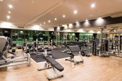 a gym with lots of treadmills and machines at Hotel Marinela Sofia in Sofia