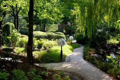 a garden with a sign next to a path at Hotel Marinela Sofia in Sofia