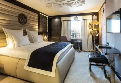 a hotel room with a large bed and a desk at Hotel Marinela Sofia in Sofia