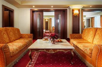 a living room with two couches and a coffee table at Grand Hotel Sofia in Sofia