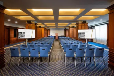 an empty room with chairs and podiums in a room at Grand Hotel Sofia in Sofia