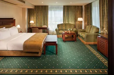 a hotel room with a bed and a chair at Grand Hotel Sofia in Sofia