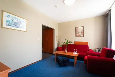 a living room with a red couch and a table at Sveta Sofia Hotel in Sofia