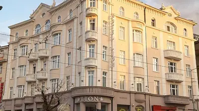 a large yellow building with a lot of windows at Hotel Lion Sofia in Sofia