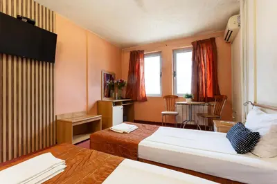 a hotel room with two beds and a table at Hotel Brod - Free Parking in Sofia