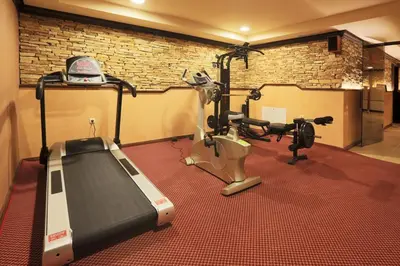 a gym with two exercise bikes and a treadmill at Royal Park Spa Bansko, private apartments within the complex in Bansko