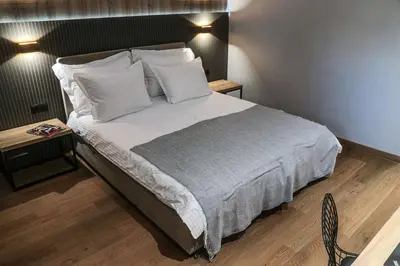 a bedroom with a large bed with white sheets and pillows at Best Western Plus Lozenetz Hotel in Sofia