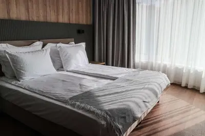 a bed with white sheets and pillows in a bedroom at Best Western Plus Lozenetz Hotel in Sofia