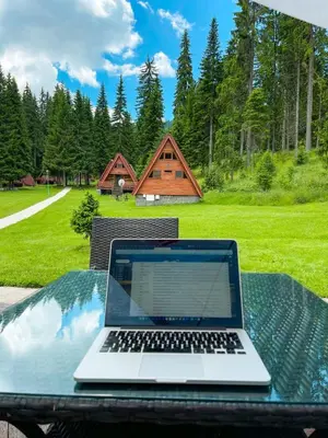 a laptop computer sitting on a table on a picnic table at Complex Malina Pamporovo in Pamporovo