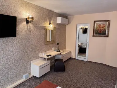 a bathroom with two sinks and a mirror at Hotel Dafi in Plovdiv