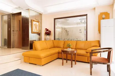 a living room with a couch and a table at Hotel Dafi in Plovdiv
