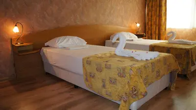 two beds in a room with swans on them at Hotel Akord - Free Parking & Metro Access in Sofia