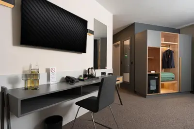 a room with a black desk and a chair at Jasmin Hotel in Sofia