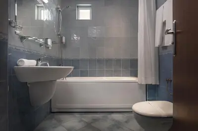 a bathroom with a sink and a tub and a toilet at Jasmin Hotel in Sofia