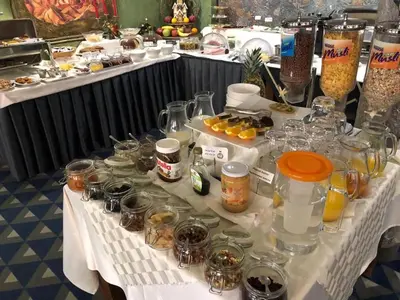 a table topped with glasses and jars of food at Art 'Otel in Sofia