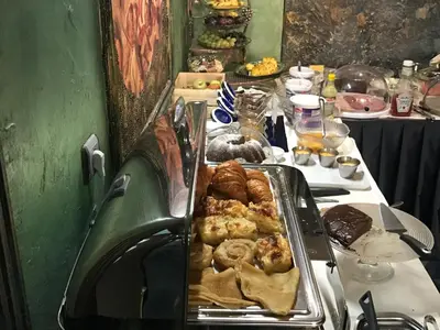 a table with a tray of pastries on it at Art 'Otel in Sofia