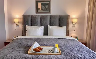 a tray of food on a bed with a tray of pastries at Art 'Otel in Sofia