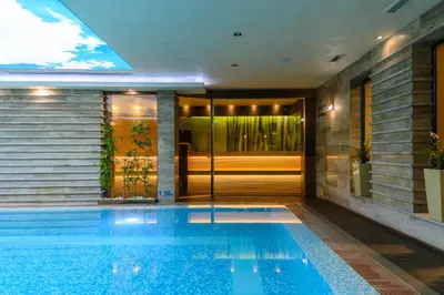 a swimming pool in the middle of a house at Spa Hotel Ezeretz Blagoevgrad in Blagoevgrad