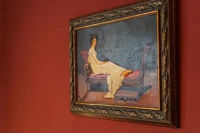 a painting of a woman sitting on a chair at Hotel Avion - Self check in in Plovdiv