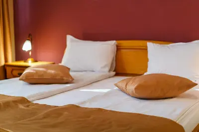 two beds with pillows on them in a bedroom at Hotel Avion - Self check in in Plovdiv