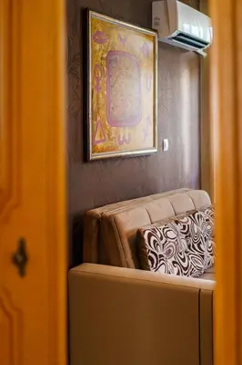 a living room with a couch and a painting at Hotel Avion - Self check in in Plovdiv