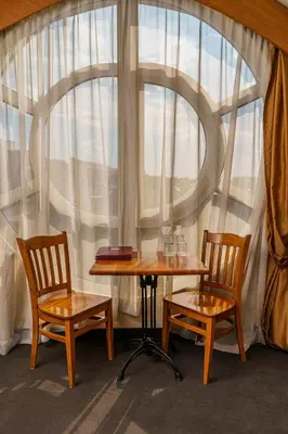 a table and two chairs in front of a window at Hotel Avion - Self check in in Plovdiv