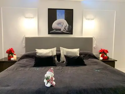 a bedroom with a large bed with a snowman toy on it at Atlantic Hotel - Free Parking in Sofia