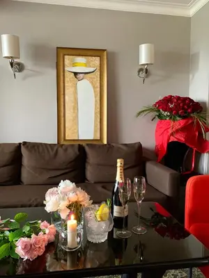 a living room with a couch and a table with wine glasses at Atlantic Hotel - Free Parking in Sofia