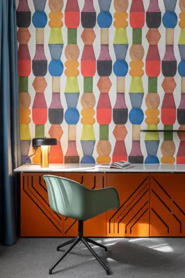 a desk with a chair in front of a colorful wall at Oborishte 63,The Art Boutique Hotel by Sandglass in Sofia