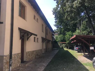 a building with a walkway next to a house at Hotel Gloria Palace Diplomat in Sofia