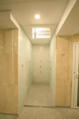 a hallway in a building with a sign on the ceiling at Perun Hotel Sandanski in Sandanski
