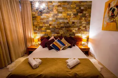 a bedroom with a bed with pillows and a brick wall at St. John Hill Bansko in Bansko