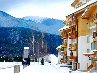 a snow covered street in front of a building at St. John Hill Bansko in Bansko