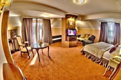 a hotel room with a bed and a table at Meg-Lozenetz Hotel in Sofia