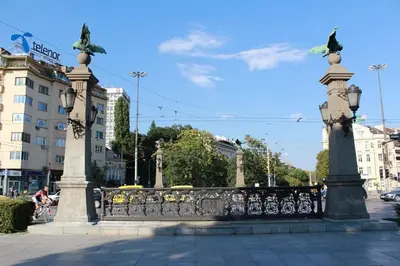 a fence with two statues on top of it at DITER Family Hotel in Sofia