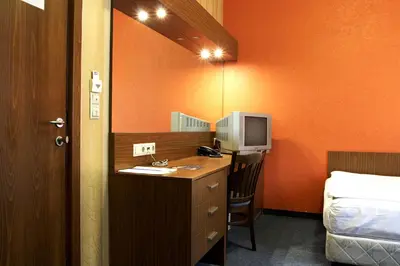 a room with a desk with a computer on it at DITER Family Hotel in Sofia