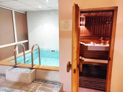 a bathroom with a swimming pool and a door to a room at Troyan Plaza Hotel in Troyan