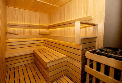 a wooden sauna with wooden floors and wooden walls at Spa Hotel Rich in Velingrad