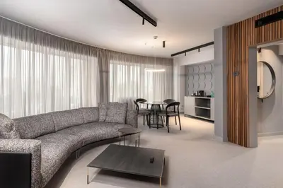 a living room with a couch and a table at Hotel VEGA Sofia in Sofia