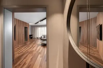 a hallway with a living room with a mirror at Hotel VEGA Sofia in Sofia