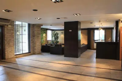 a lobby with couches and tables in a building at Fortuna Luxury Apartment in Bansko